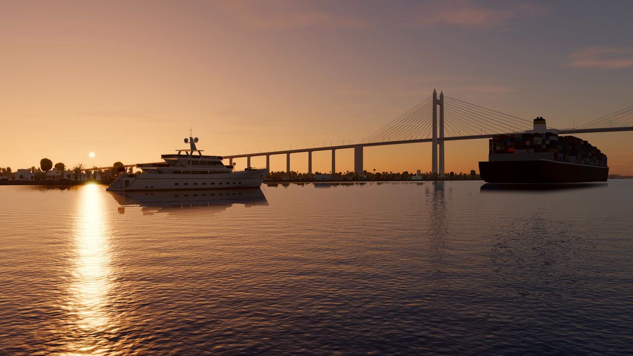 A superyacht at sunset on the Suez Canal, the bridge and a container ship behind her, in Yacht Skipper